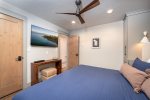 The primary bedroom offers a cozy king bed & private television.